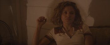 Movie still from “The Diary of a Teenage Girl” (2015), directed by Marielle Heller – A woman holding a cell phone in her hand; Close Up shot, Over the shoulder angle