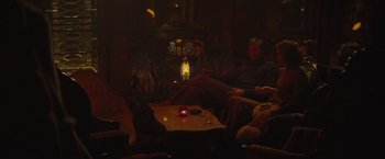 Movie still from “The Diary of a Teenage Girl” (2015), directed by Marielle Heller – A man sitting on a couch in a living room; Wide shot, High angle