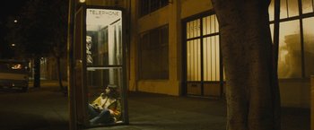 Movie still from “The Diary of a Teenage Girl” (2015), directed by Marielle Heller – A woman sitting on the ground next to a phone booth; Wide shot, High angle