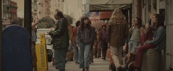 Movie still from “The Diary of a Teenage Girl” (2015), directed by Marielle Heller – A group of people walking down a street; Wide shot, High angle