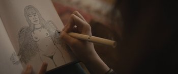 Movie still from “The Diary of a Teenage Girl” (2015), directed by Marielle Heller – A person is holding a pencil and drawing a picture; Extreme Close Up shot, Over the shoulder angle