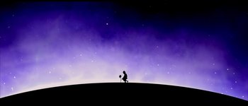 Movie still from “Le Dîner de Cons” (1998), directed by Francis Veber – A person sitting on top of a hill; Extreme Wide shot, Low angle