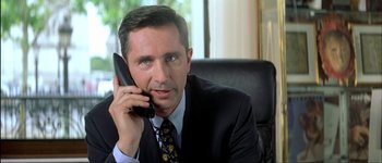 Movie still from “Le Dîner de Cons” (1998), directed by Francis Veber – A person talking on a cell phone; Close Up shot, Low angle