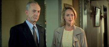 Movie still from “Le Dîner de Cons” (1998), directed by Francis Veber – A man and a woman standing next to each other; Close Up shot, Low angle