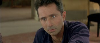 Movie still from “Le Dîner de Cons” (1998), directed by Francis Veber – A person with blue eyes; Close Up shot, Low angle