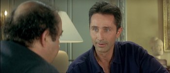 Movie still from “Le Dîner de Cons” (1998), directed by Francis Veber – A person talking to another person; Close Up shot, Over the shoulder angle