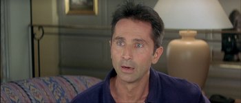 Movie still from “Le Dîner de Cons” (1998), directed by Francis Veber – A person with blue eyes looking at the camera; Close Up shot, High angle