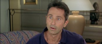 Movie still from “Le Dîner de Cons” (1998), directed by Francis Veber – A person with blue eyes looking at the camera; Close Up shot, High angle