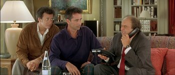 Movie still from “Le Dîner de Cons” (1998), directed by Francis Veber – A group of men sitting on a couch; Medium shot, High angle