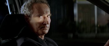 Movie still from “Le Dîner de Cons” (1998), directed by Francis Veber – An older man is looking into the distance; Close Up shot, Low angle