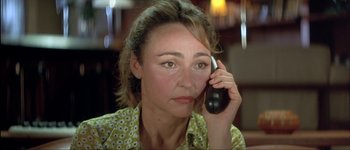 Movie still from “Le Dîner de Cons” (1998), directed by Francis Veber – A person talking on a cell phone; Close Up shot, High angle