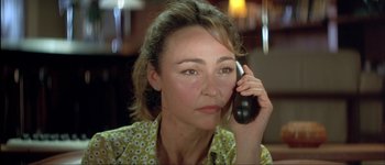 Movie still from “Le Dîner de Cons” (1998), directed by Francis Veber – A person talking on a cell phone; Close Up shot, High angle