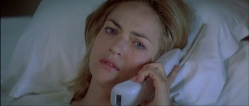 Movie still from “Le Dîner de Cons” (1998), directed by Francis Veber – A woman is talking on a phone while lying in bed; Close Up shot, High angle