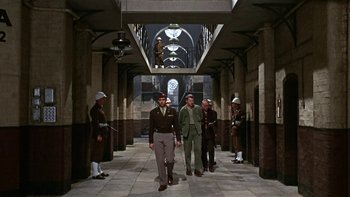 Movie still from “The Dirty Dozen” (1967), directed by Robert Aldrich – A group of men standing in an archway in a building; Wide shot, Low angle