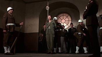 Movie still from “The Dirty Dozen” (1967), directed by Robert Aldrich – A group of men standing in front of a window; Medium shot, Low angle