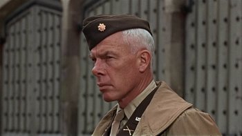 Movie still from “The Dirty Dozen” (1967), directed by Robert Aldrich – An older man in a military uniform looking to his left; Close Up shot, Low angle