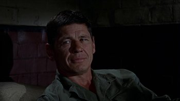Movie still from “The Dirty Dozen” (1967), directed by Robert Aldrich – A person wearing a green shirt; Close Up shot, Low angle