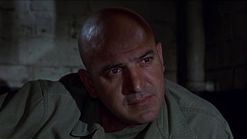 Movie still from “The Dirty Dozen” (1967), directed by Robert Aldrich – A man with bald head looking into the camera; Close Up shot, Low angle
