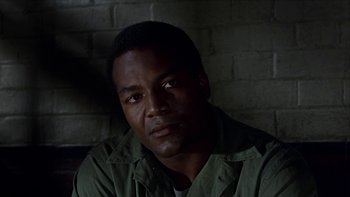 Movie still from “The Dirty Dozen” (1967), directed by Robert Aldrich – A man in a green jacket is looking at the camera; Close Up shot, Low angle