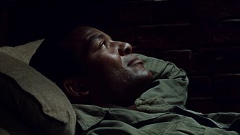 Movie still from “The Dirty Dozen” (1967), directed by Robert Aldrich – A person laying on the ground; Close Up shot, High angle