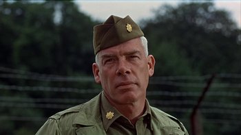 Movie still from “The Dirty Dozen” (1967), directed by Robert Aldrich – An older man in a military uniform with his eyes wide open; Close Up shot, Low angle