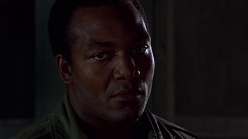 Movie still from “The Dirty Dozen” (1967), directed by Robert Aldrich – A man's face in the dark; Close Up shot, Low angle