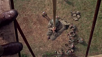 Movie still from “The Dirty Dozen” (1967), directed by Robert Aldrich – An aerial view of a soldier hanging from a rope; Wide shot, Overhead angle