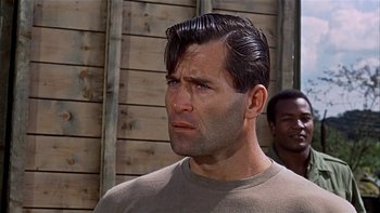 Movie still from “The Dirty Dozen” (1967), directed by Robert Aldrich – A person wearing a sweater; Close Up shot, Over the shoulder angle