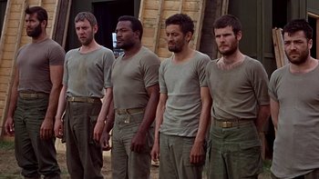 Movie still from “The Dirty Dozen” (1967), directed by Robert Aldrich – A group of men standing next to each other; Medium shot, Low angle