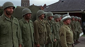 Movie still from “The Dirty Dozen” (1967), directed by Robert Aldrich – A group of men standing next to each other wearing helmets; Medium shot, Low angle
