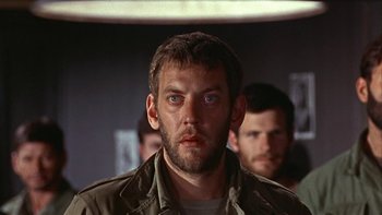 Movie still from “The Dirty Dozen” (1967), directed by Robert Aldrich – A person wearing a jacket and staring straight ahead; Close Up shot, Low angle