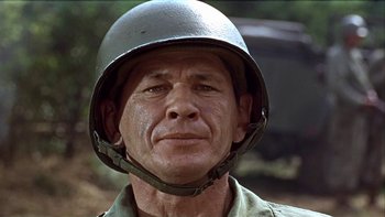 Movie still from “The Dirty Dozen” (1967), directed by Robert Aldrich – An older man wearing a military helmet; Close Up shot, Low angle