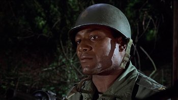 Movie still from “The Dirty Dozen” (1967), directed by Robert Aldrich – A man wearing a helmet is looking into the distance; Close Up shot, Low angle