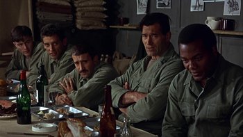 Movie still from “The Dirty Dozen” (1967), directed by Robert Aldrich – A group of men sitting at a dinner table; Medium shot, Over the shoulder angle