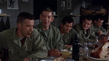 Movie still from “The Dirty Dozen” (1967), directed by Robert Aldrich – A group of men sitting at a dinner table; Medium shot, Low angle