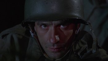Movie still from “The Dirty Dozen” (1967), directed by Robert Aldrich – A man wearing a helmet and a uniform; Close Up shot, Low angle
