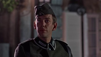 Movie still from “The Dirty Dozen” (1967), directed by Robert Aldrich – A person wearing a uniform; Close Up shot, Low angle