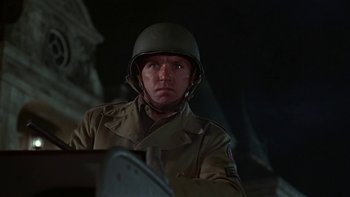 Movie still from “The Dirty Dozen” (1967), directed by Robert Aldrich – A man in a military uniform wearing a helmet; Close Up shot, Low angle