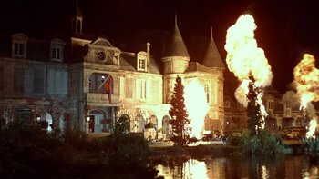 Movie still from “The Dirty Dozen” (1967), directed by Robert Aldrich – An old building with a fire coming out of it's chimney; Extreme Wide shot, Low angle