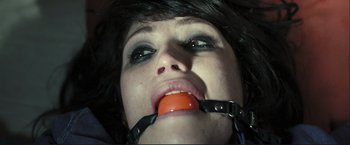 Movie still from “The Disappearance of Alice Creed” (2009), directed by J Blakeson – A woman with a ball gag in her mouth; Extreme Close Up shot, Overhead angle