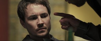 Movie still from “The Disappearance of Alice Creed” (2009), directed by J Blakeson – A person pointing at a man; Close Up shot, Over the shoulder angle