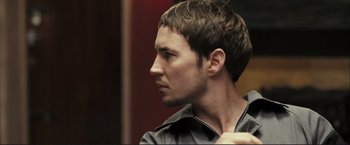 Movie still from “The Disappearance of Alice Creed” (2009), directed by J Blakeson – A person wearing a leather jacket; Close Up shot, Low angle