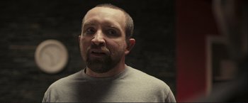 Movie still from “The Disappearance of Alice Creed” (2009), directed by J Blakeson – A man with a goatee and a beard looking at the camera; Close Up shot, Low angle