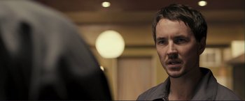 Movie still from “The Disappearance of Alice Creed” (2009), directed by J Blakeson – A person in a room looking at a mirror; Close Up shot, Over the shoulder angle