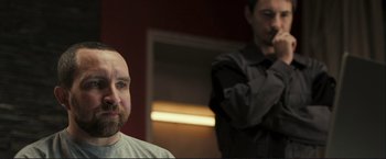 Movie still from “The Disappearance of Alice Creed” (2009), directed by J Blakeson – A man with a goatee and a beard; Close Up shot, Over the shoulder angle