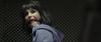 Movie still from “The Disappearance of Alice Creed” (2009), directed by J Blakeson – A woman with a black hair and red lipstick; Close Up shot, Over the shoulder angle