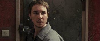 Movie still from “The Disappearance of Alice Creed” (2009), directed by J Blakeson – A person wearing a gray shirt; Close Up shot, High angle