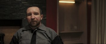 Movie still from “The Disappearance of Alice Creed” (2009), directed by J Blakeson – A man with a beard wearing a tie; Close Up shot, Over the shoulder angle