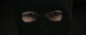 Movie still from “The Disappearance of Alice Creed” (2009), directed by J Blakeson – A person wearing a black mask; Extreme Close Up shot, Low angle