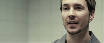 Movie still from “The Disappearance of Alice Creed” (2009), directed by J Blakeson – A person with a beard; Close Up shot, Over the shoulder angle